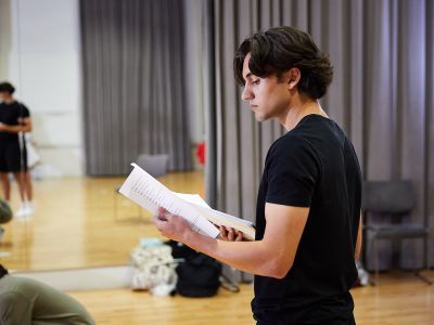 participant holding a text on acting course